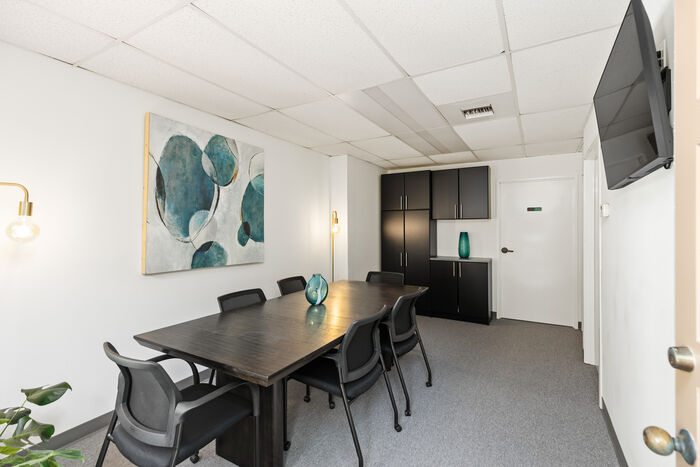 Conference room with meeting table and wall-mounted TV