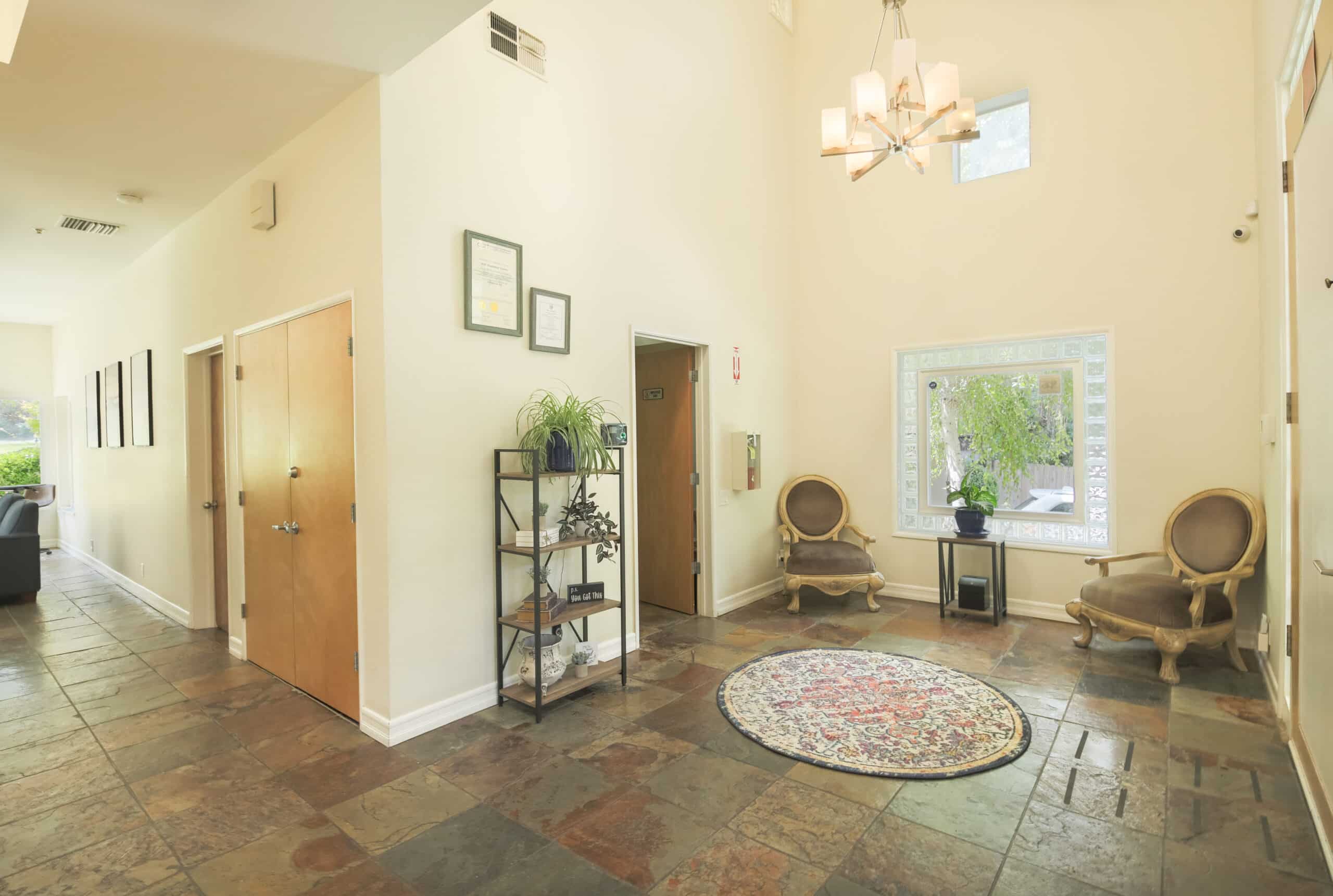 Spacious lobby with armchairs and decorative rug