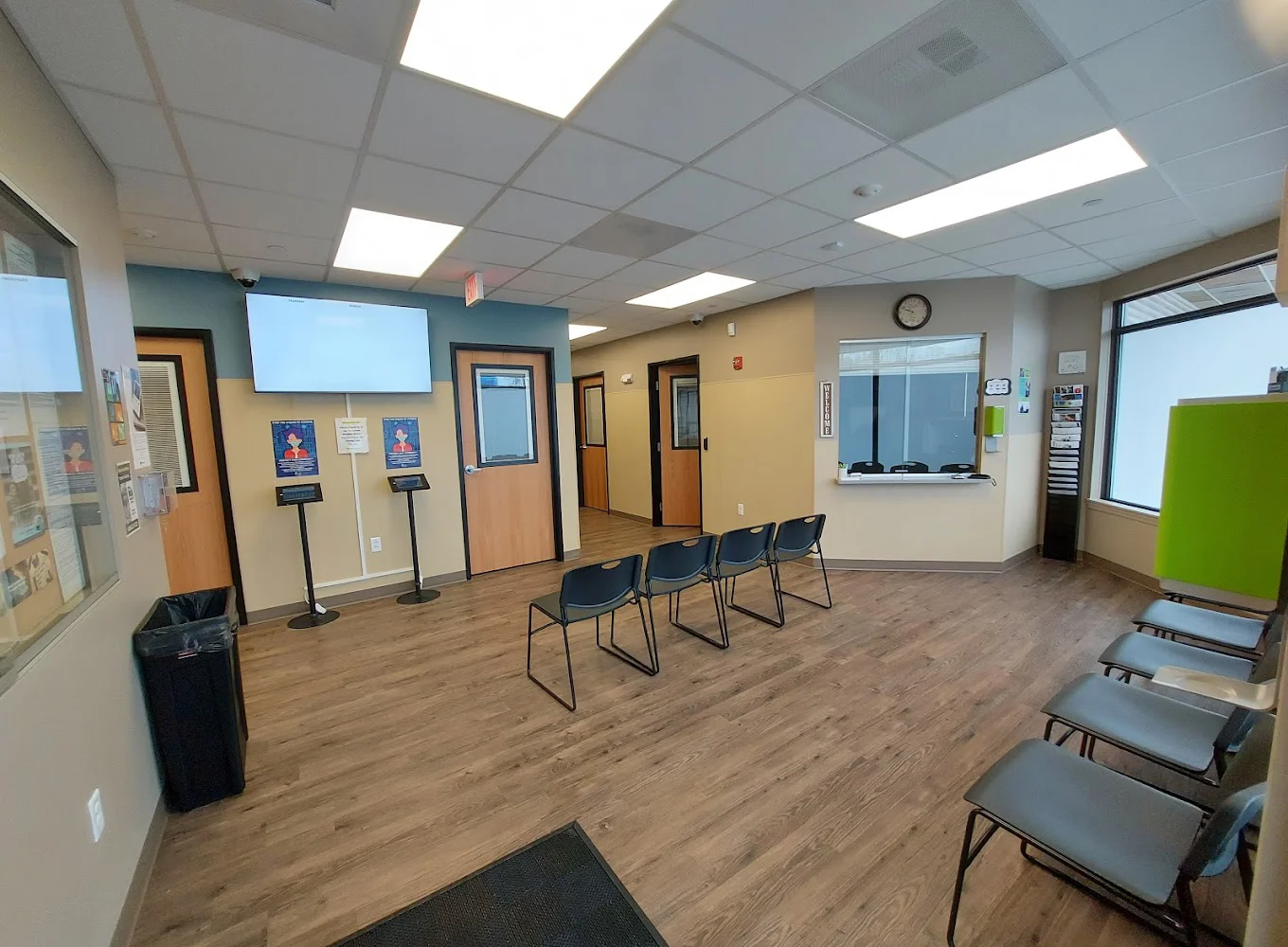 Waiting area with rows of chairs and reception window