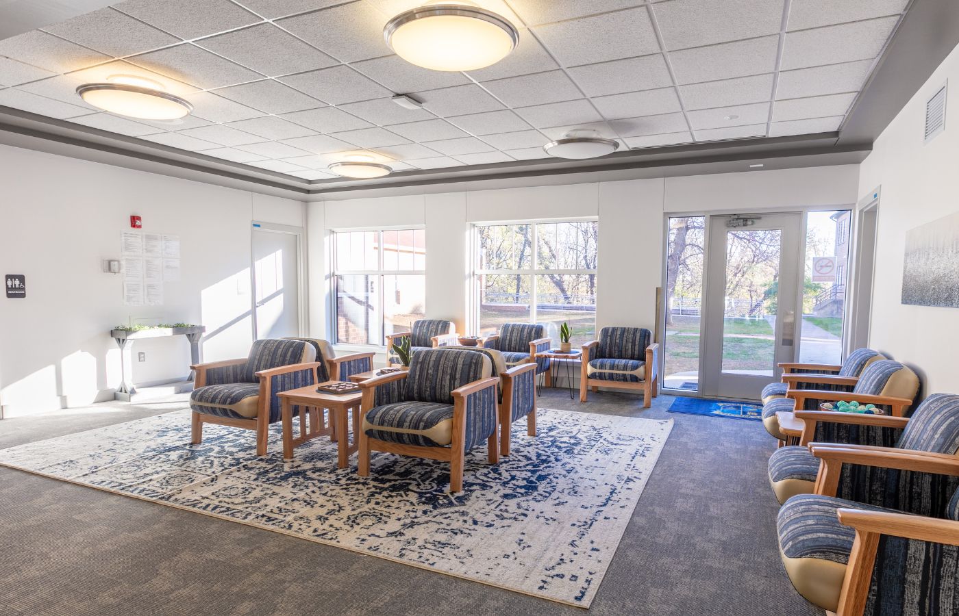 Bright lounge with armchairs and large windows