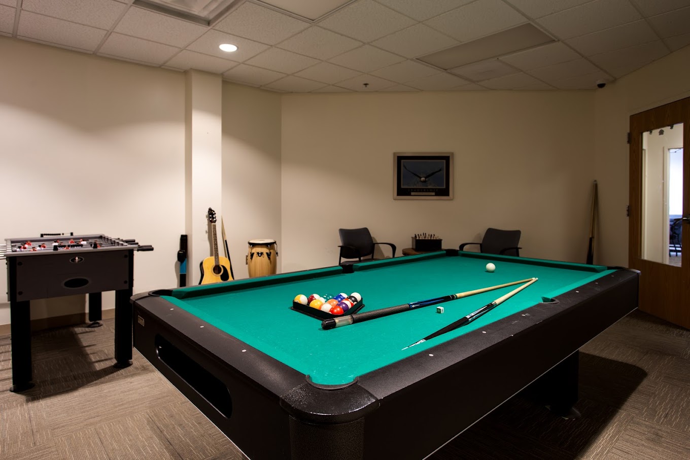 Game room with pool table and musical instruments