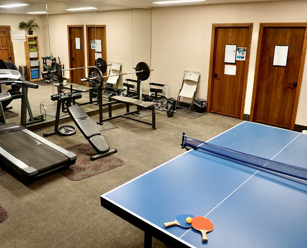Exercise room with gym gear and ping pong table