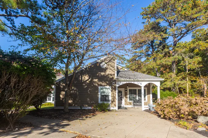 Rehab facility exterior with trees and front porch