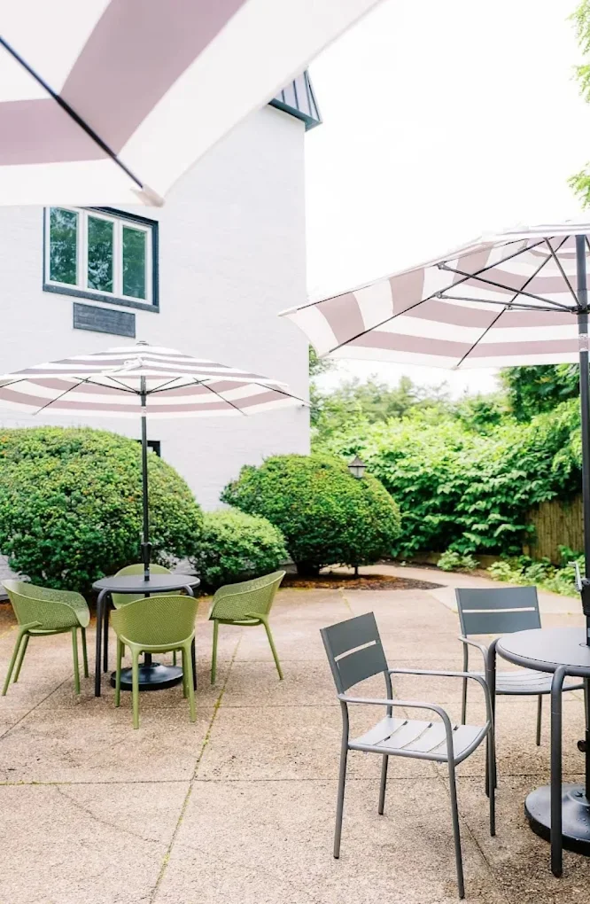 Outdoor patio with shaded seating and greenery