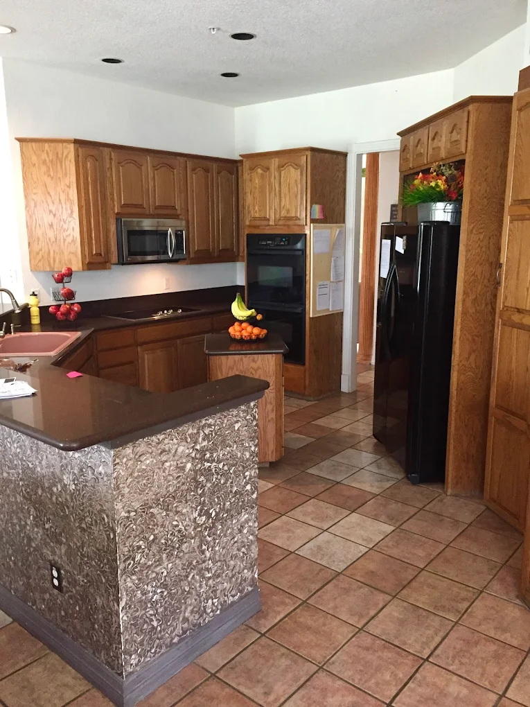 Kitchen with island oven microwave and refrigerator