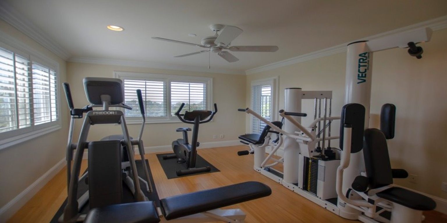 Private fitness room with cardio and strength machines.
