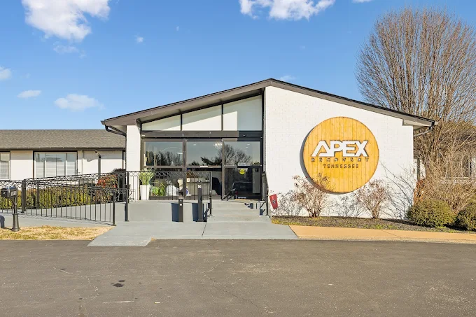 Front view of Apex Recovery building with large wood logo sign