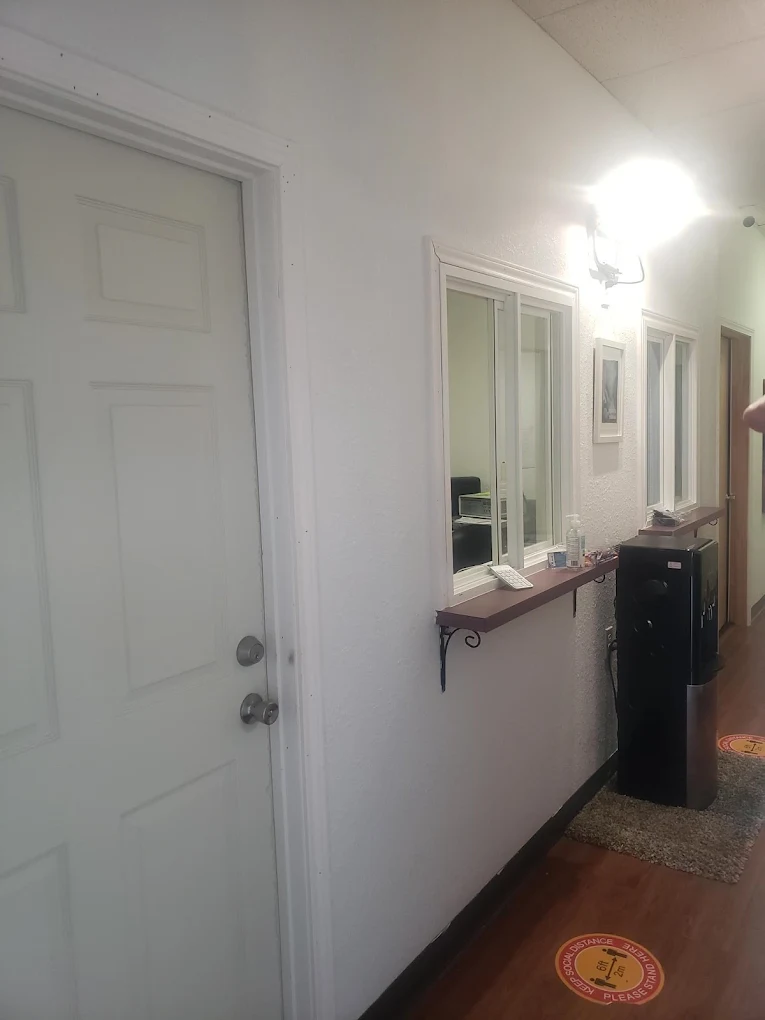 Clinic hallway showing check-in windows and doors