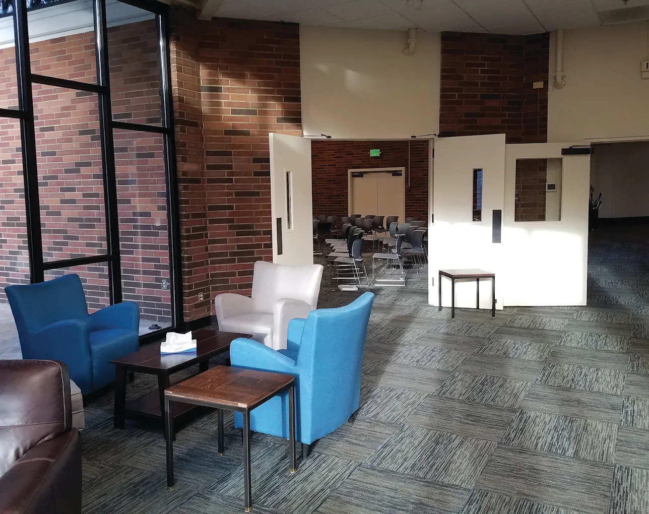 Waiting lounge with chairs and access to group room