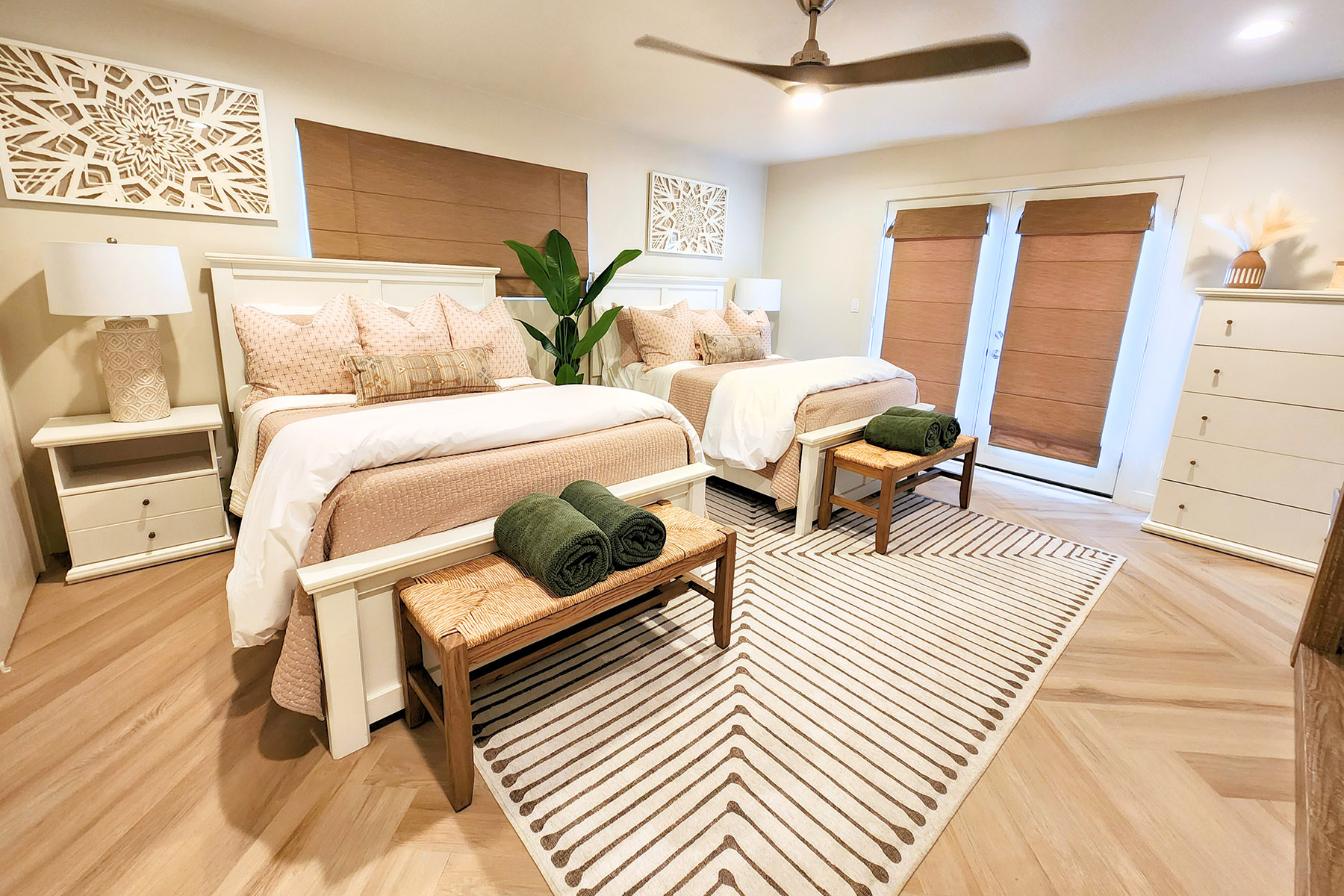 Two cozy beds with bench seating and soft lighting