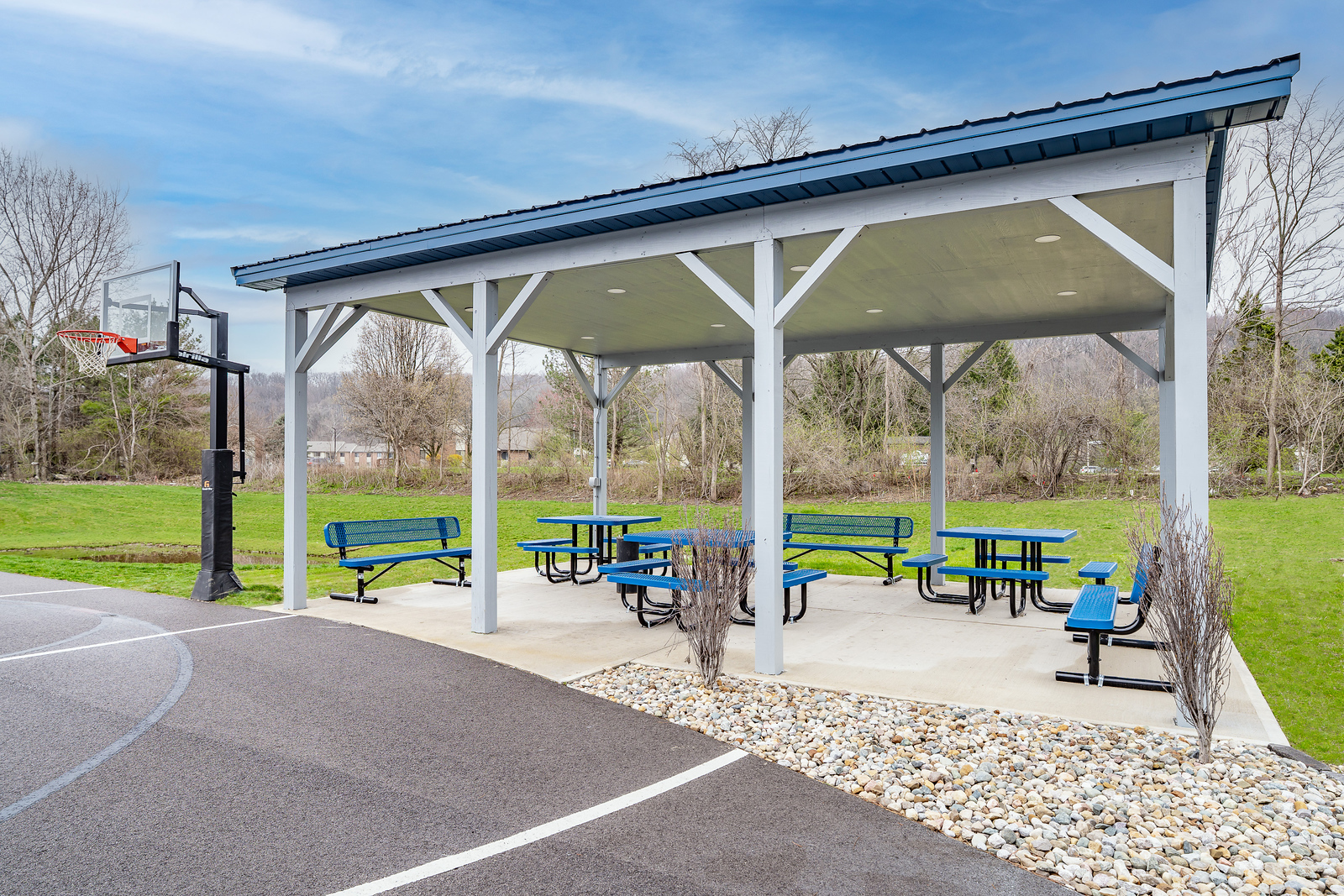 Covered picnic area beside outdoor basketball court