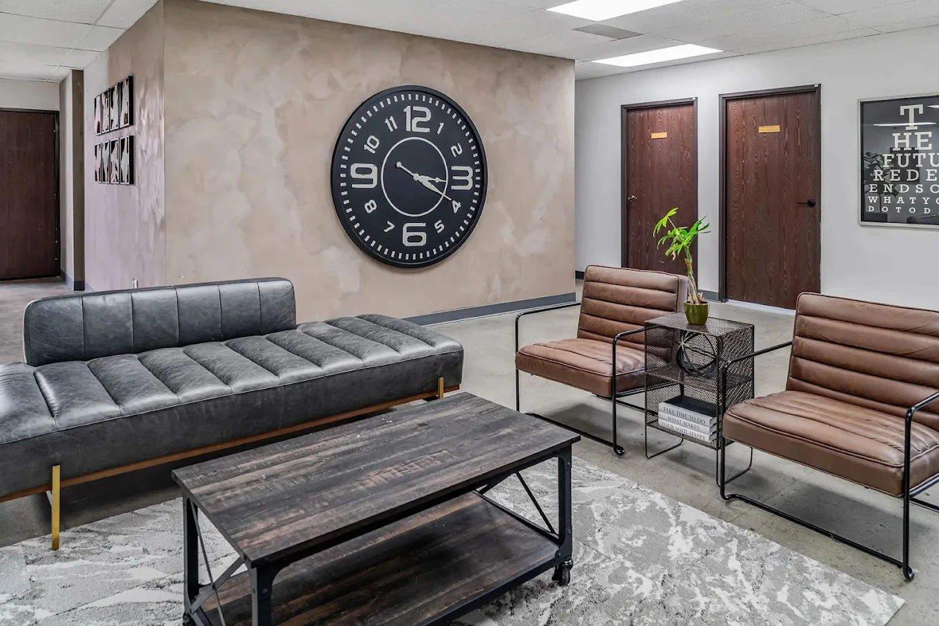 Waiting area with modern furniture, large wall clock, and welcoming decor