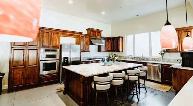 Modern kitchen with granite island and wood cabinets