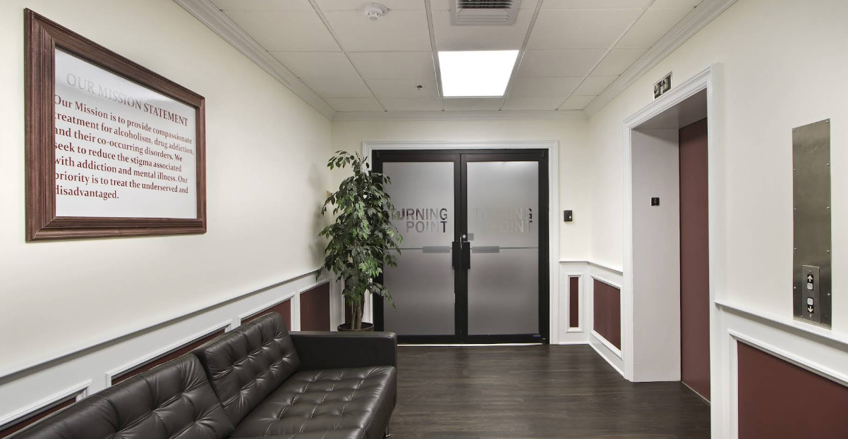 Rehab facility lobby with sofa and elevator entrance