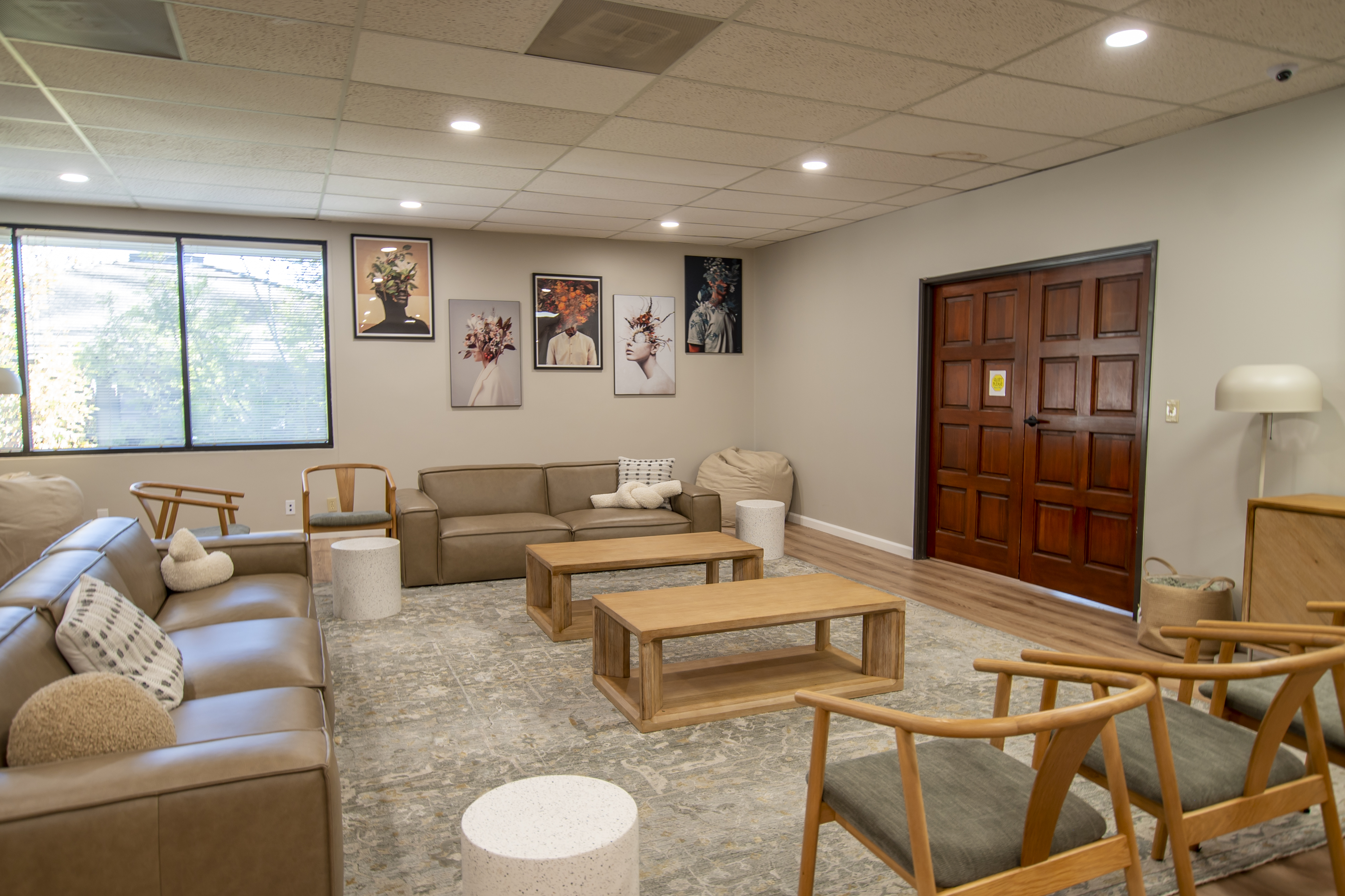 Spacious lounge with sofas, armchairs, and art