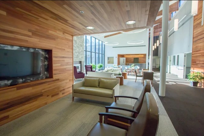 Lounge area with sofas and wood-paneled walls
