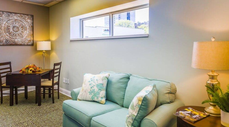 Comfortable lounge with sofa, table, and soft lighting