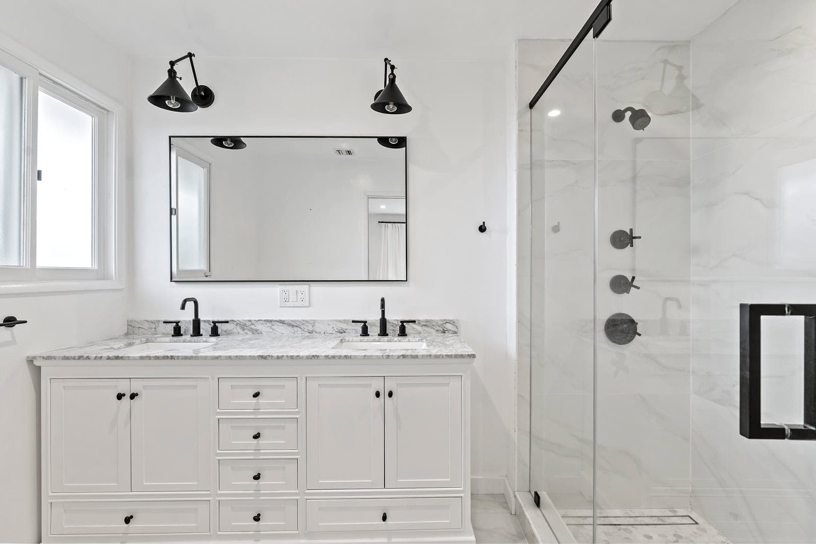 Modern bathroom with double vanity and glass shower