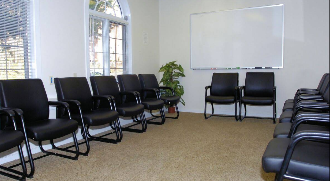 Circle of chairs in group therapy meeting room