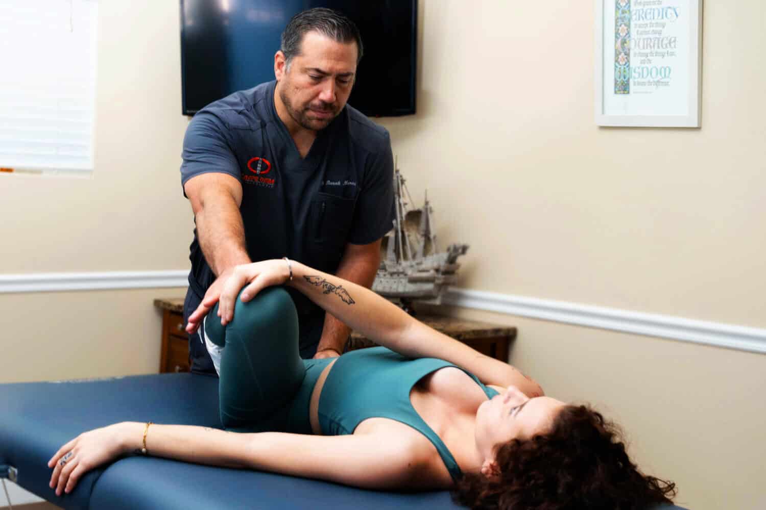 Therapist assisting with stretch on table