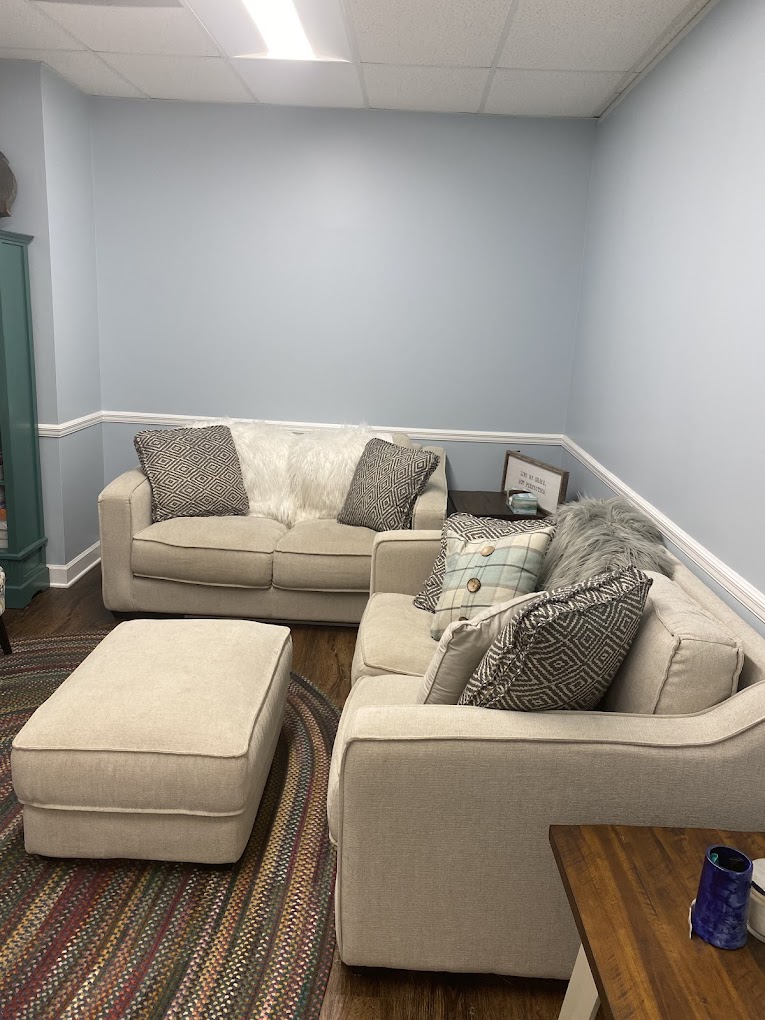 Cozy therapy room with beige sofas and decorative pillows