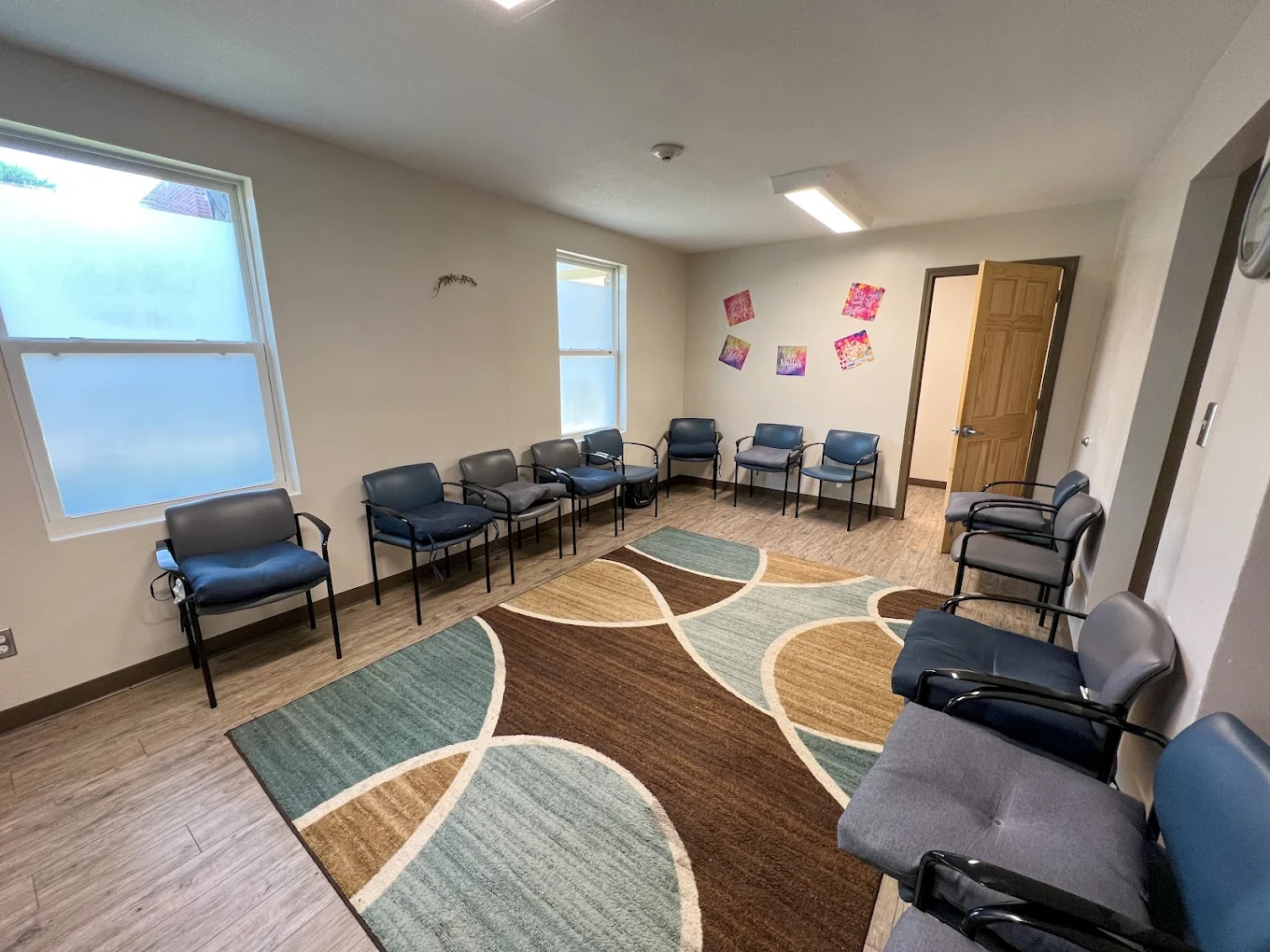 Circle of chairs in a cozy, well-lit group meeting room