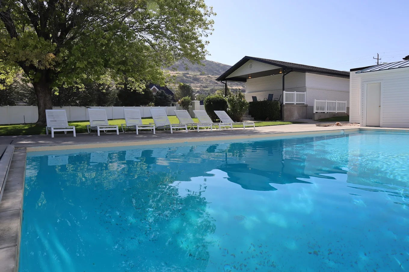 Outdoor pool and lounge chairs at Deer Hollow Mountainside Draper
