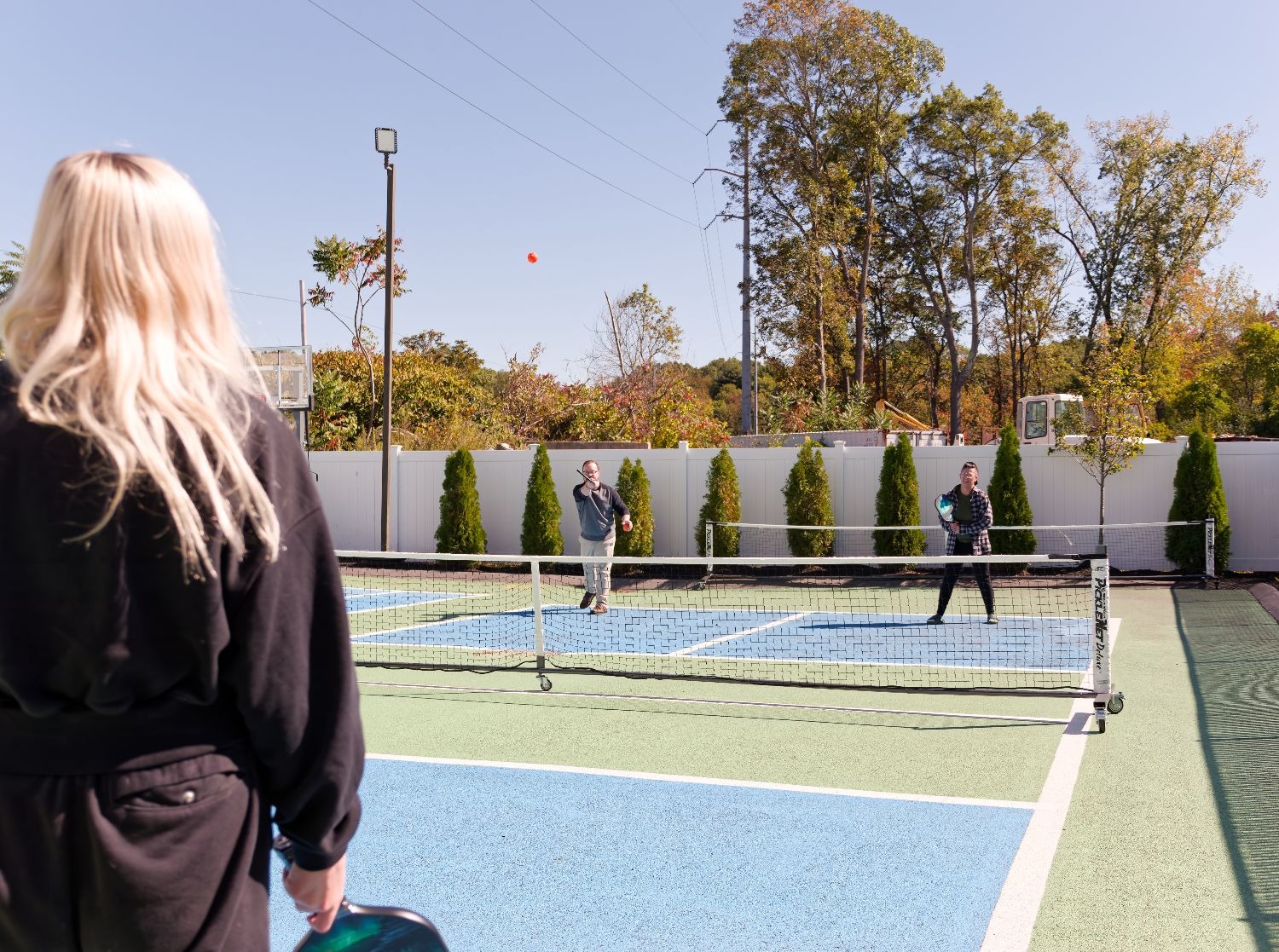 Clients playing pickleball on the outdoor court.