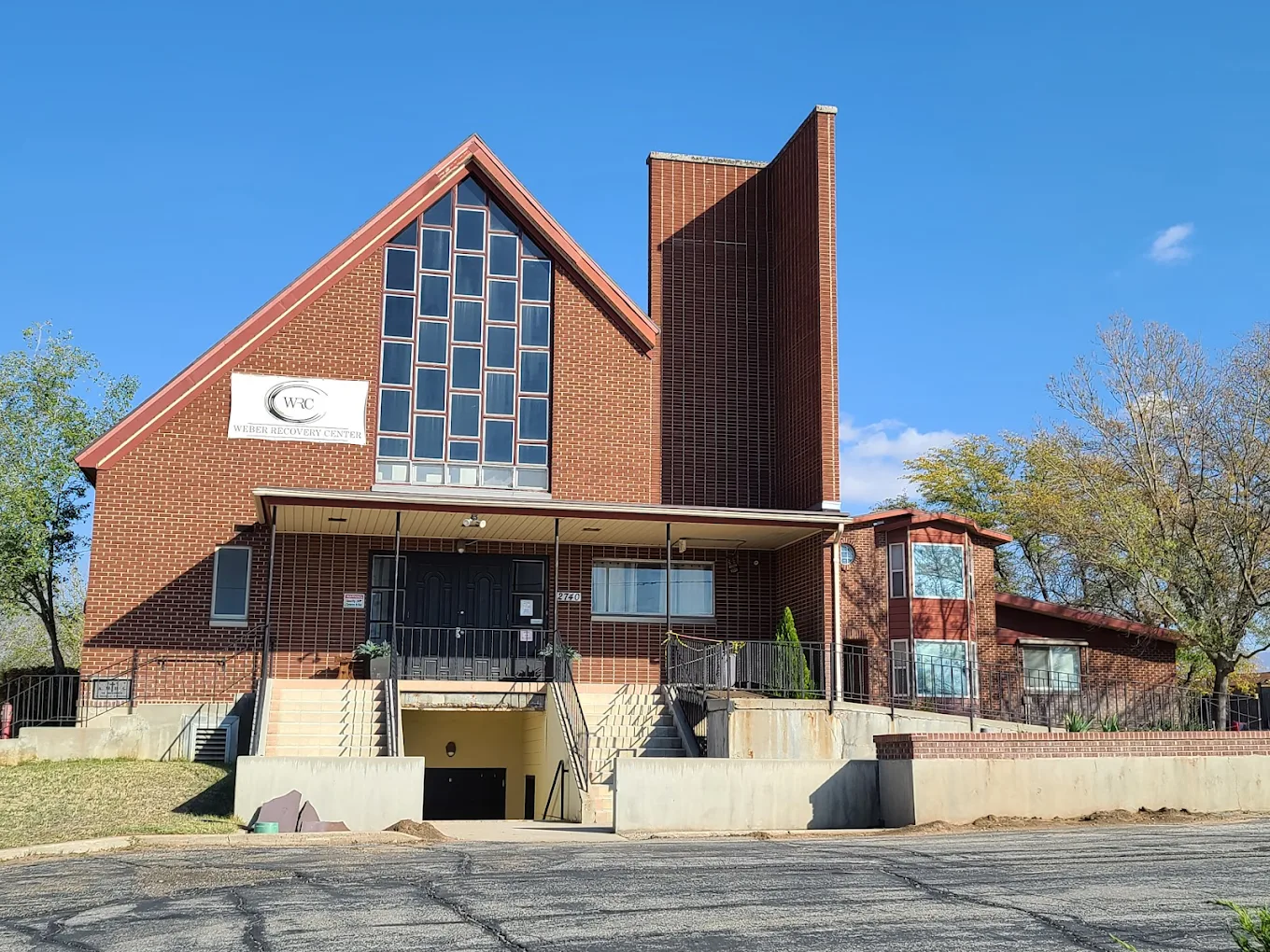 Red-brick rehab center with steep roof and front stairs