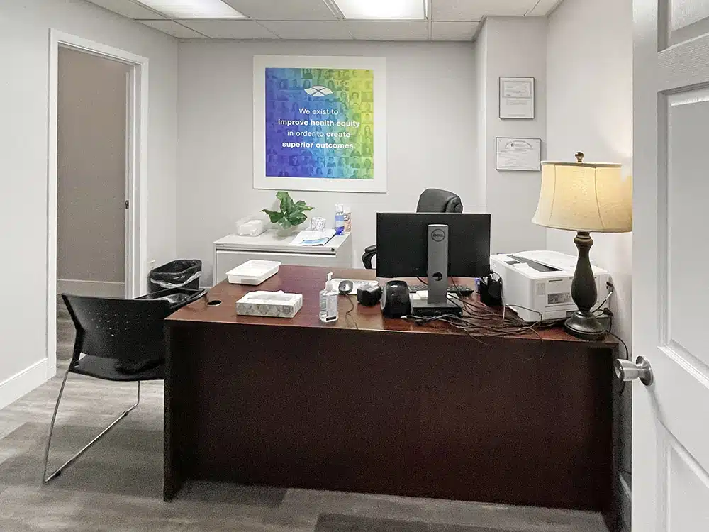 Office with desk, computer, and motivational wall art