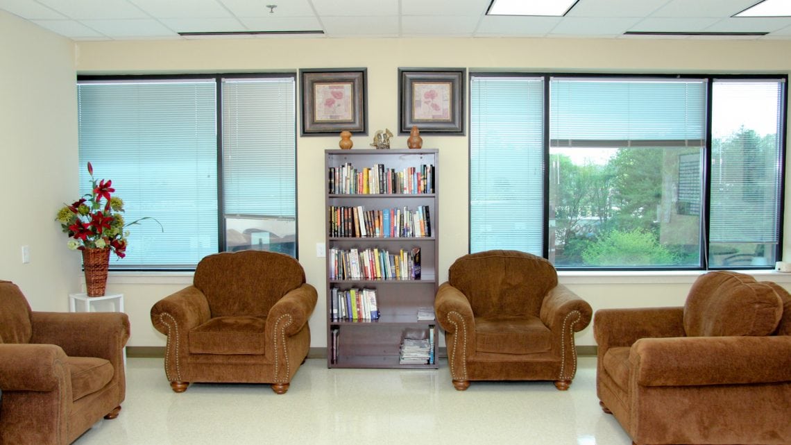 Lounge chairs and bookshelf in a cozy reading area