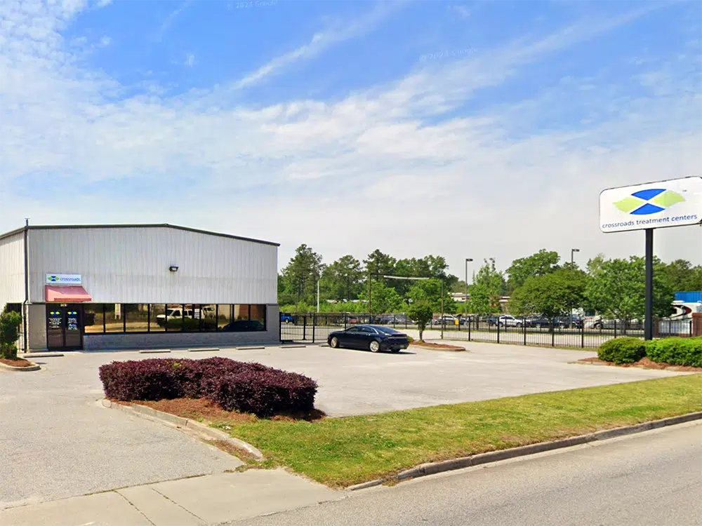 Clinic exterior with parking lot and Crossroads sign