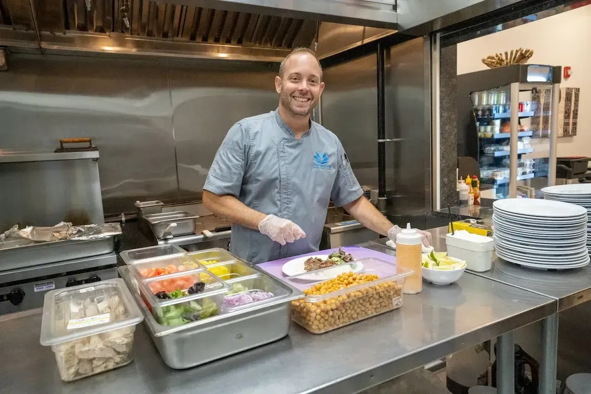 Chef preparing ingredients in the facility kitchen.