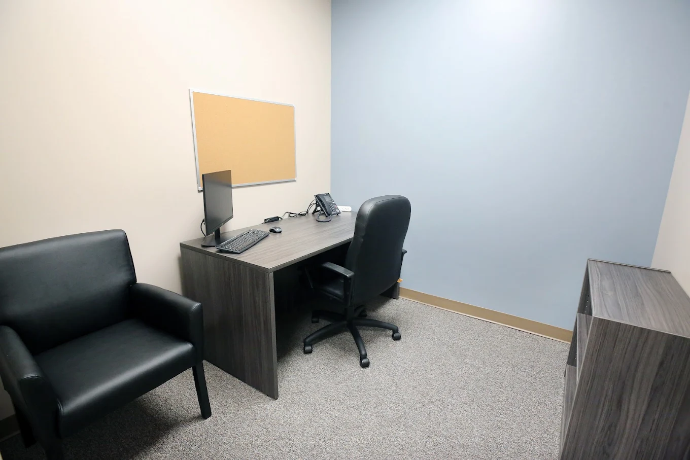 BrightView Elyria counseling room with desk, computer, office chair, and guest seating