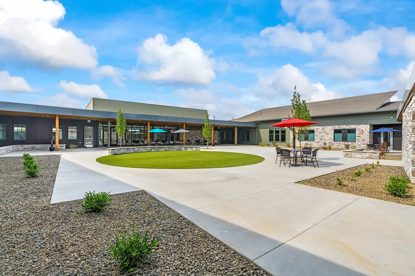 Outdoor courtyard with seating and landscaped lawn