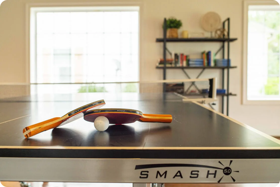 Ping pong paddles on game table indoors