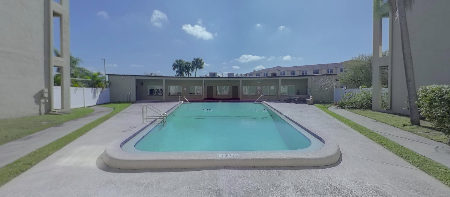 Outdoor swimming pool surrounded by facility grounds