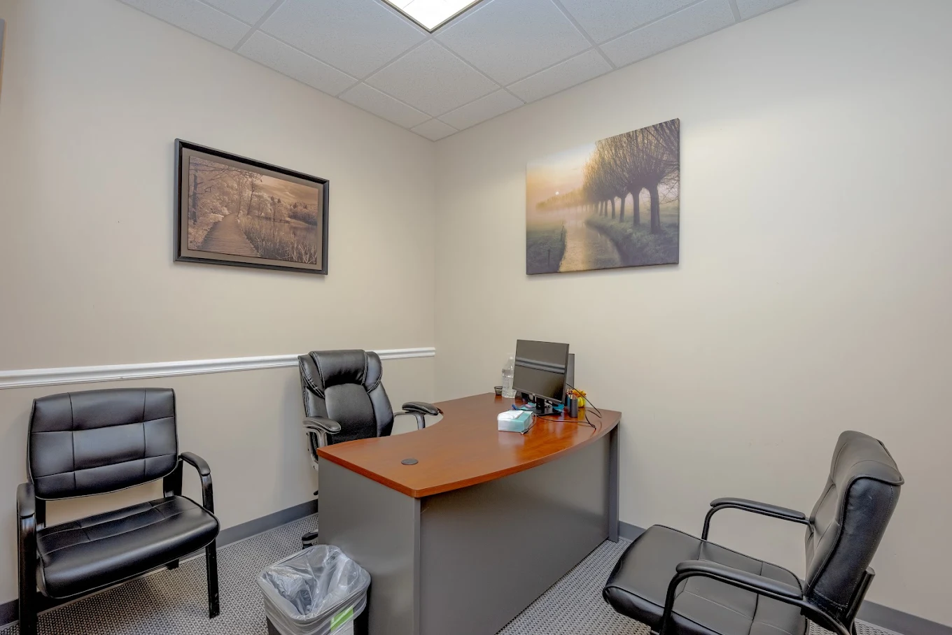 Private consultation room with desk and three chairs
