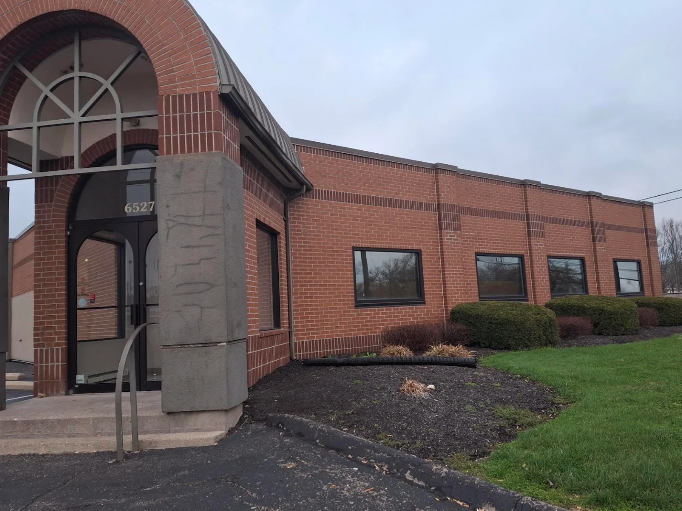 Brick entrance with glass doors and arched entryway