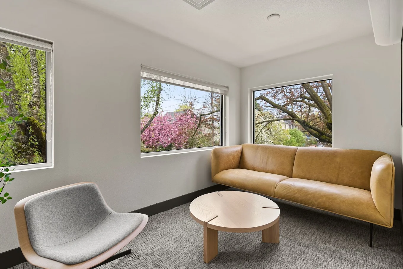 Private waiting room with sofa and large windows