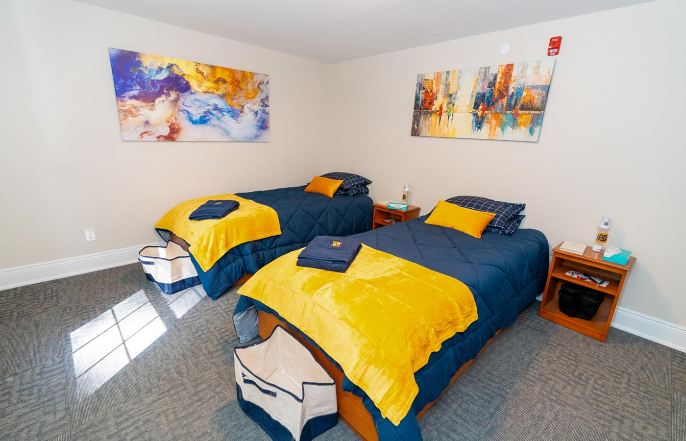 Cozy shared bedroom with two twin beds and colorful bedding.