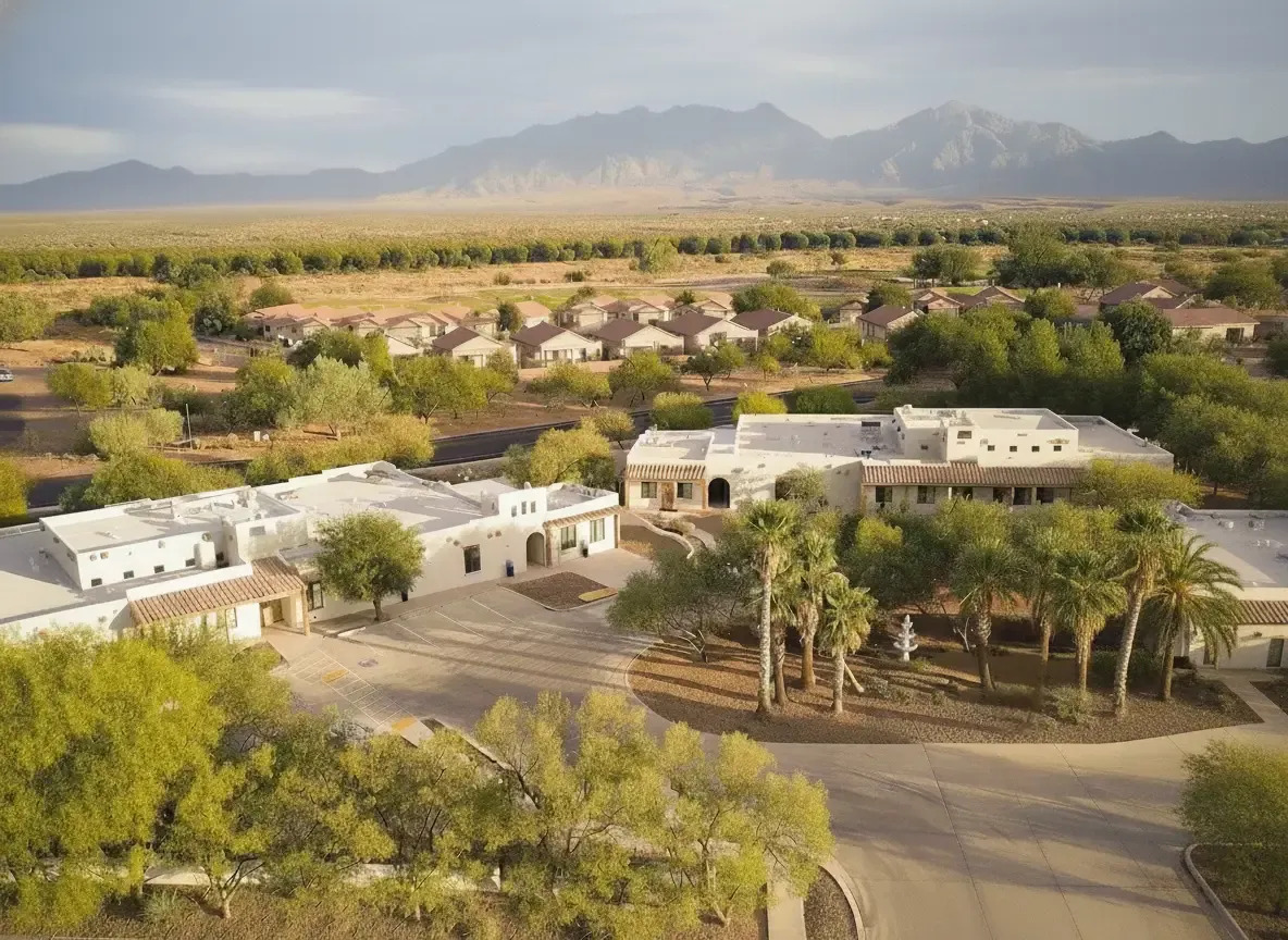 Aerial view of detox facility surrounded by trees and mountains.