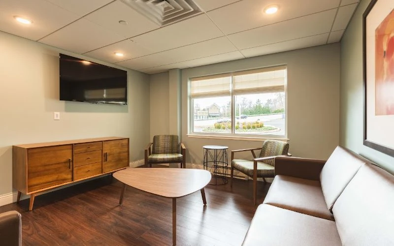 Waiting space with TV, window, and seating