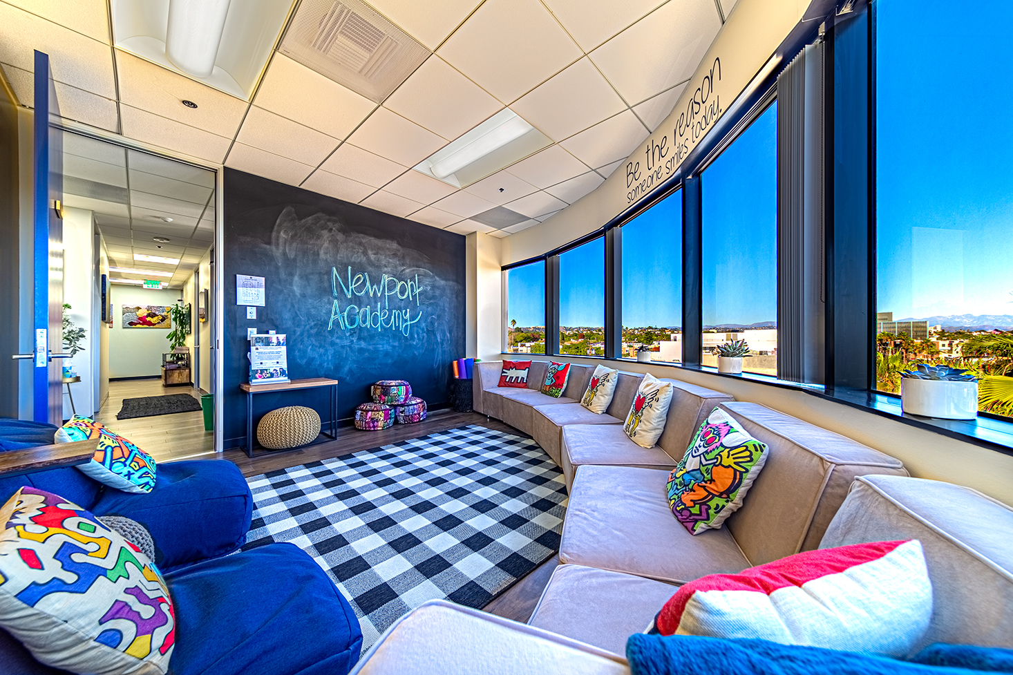 Lounge with seating and chalkboard wall.