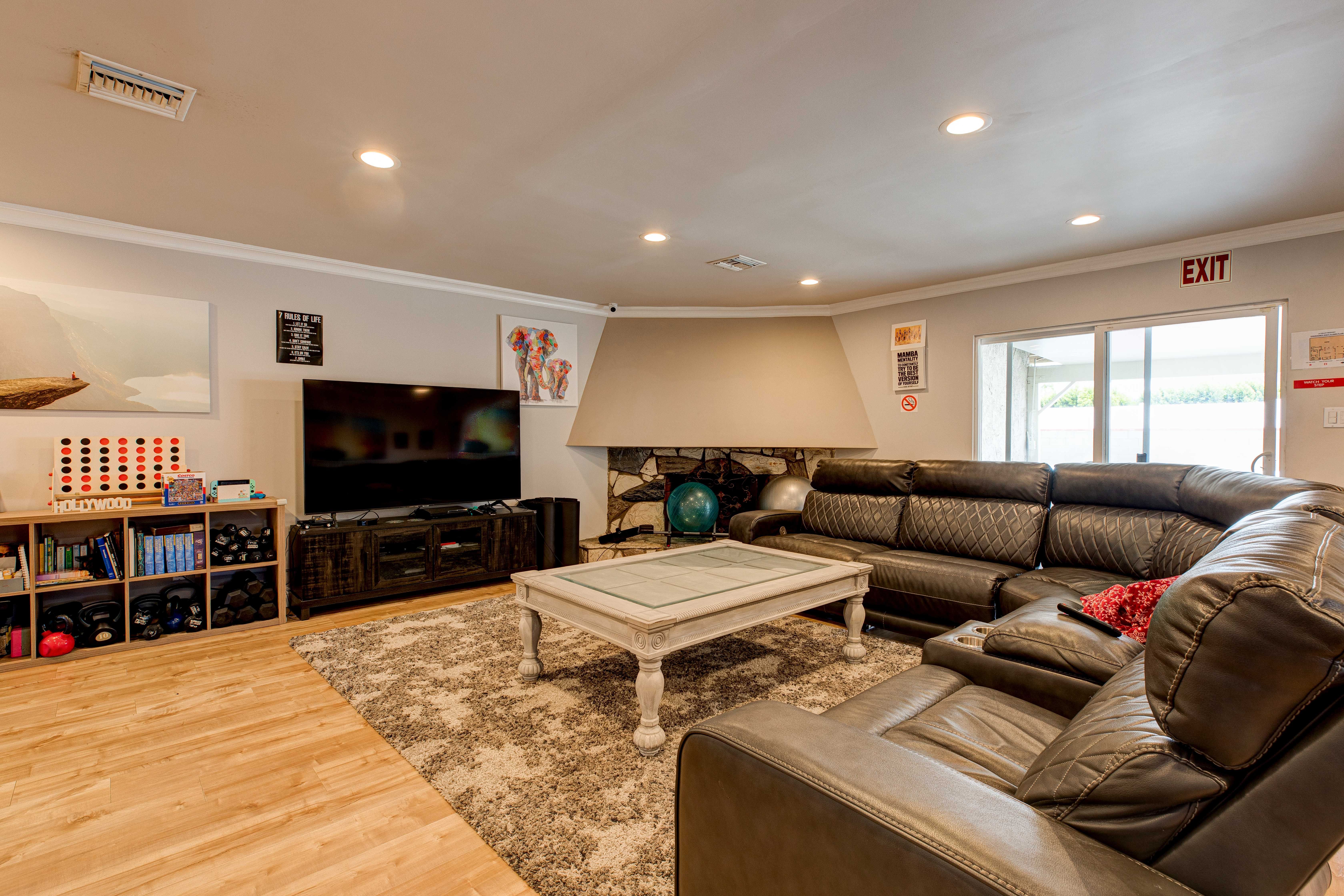 Living room withseating, a TV, and a fireplace.