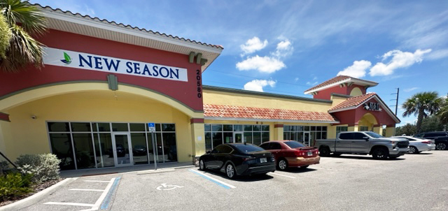 Parking space at the facility with signage on building