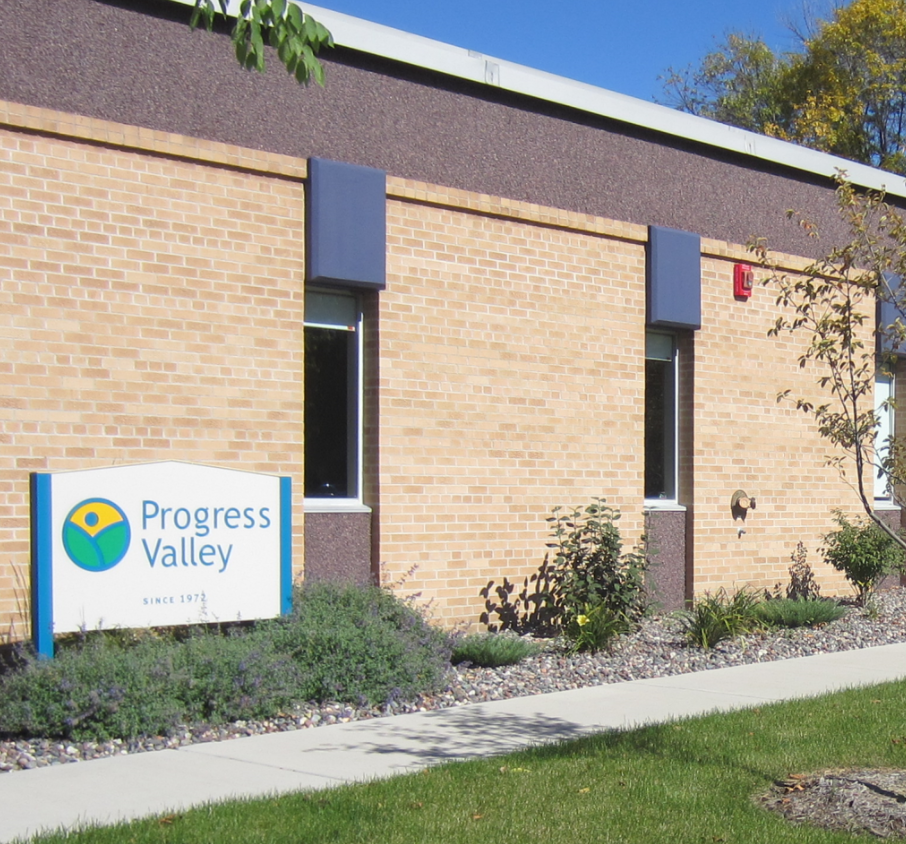 Progress Valley sign outside brick rehab building
