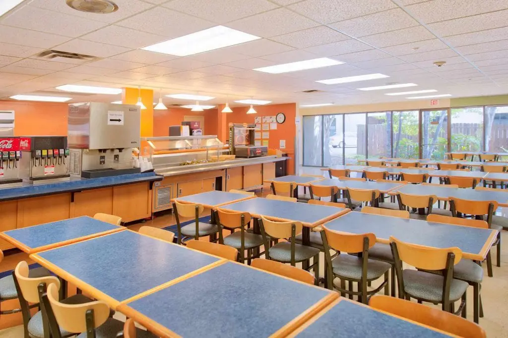 Cafeteria with buffet serving line and dining tables
