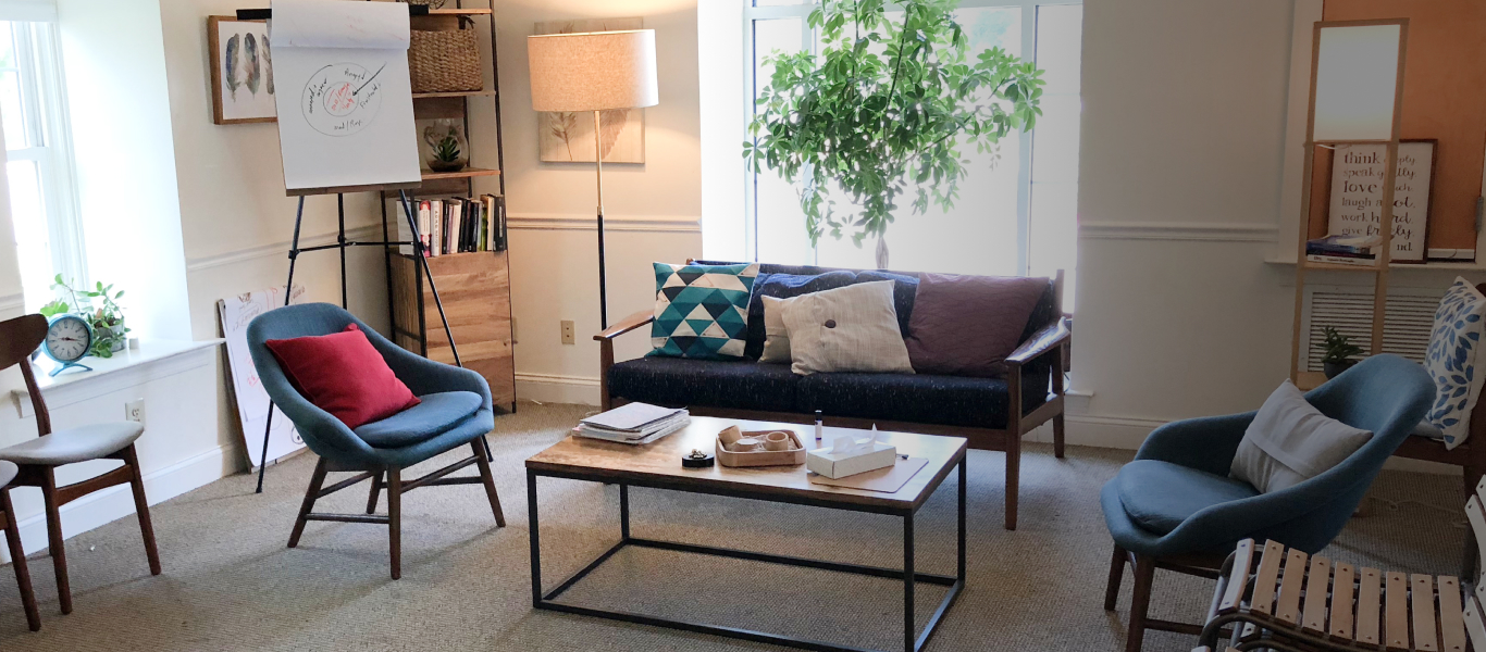 The exterior of Center for Families with a rainbow in the sky.