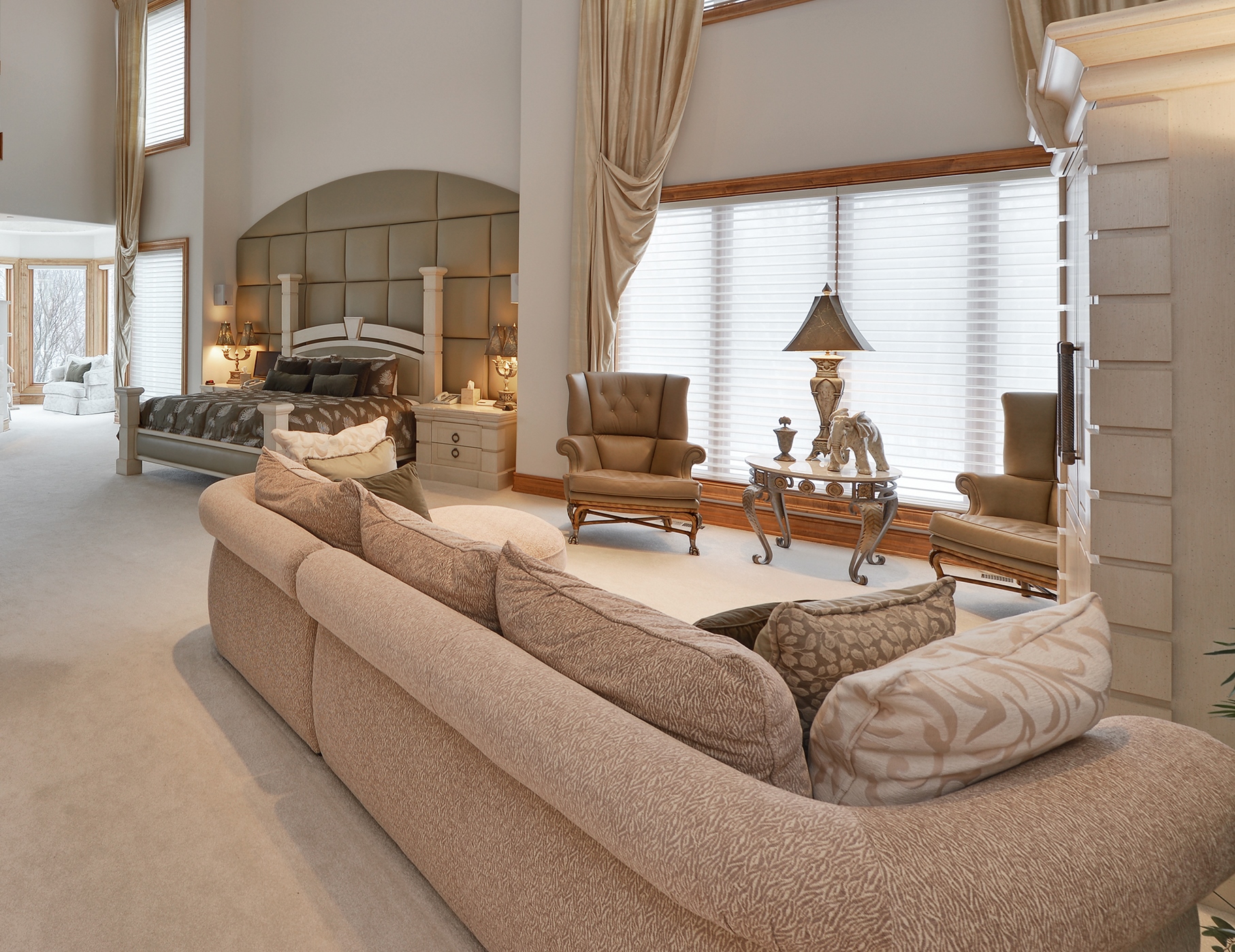 Spacious suite with seating area and high ceilings.